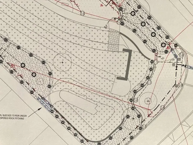 Printed irrigation design plan with sprinkler positions marked